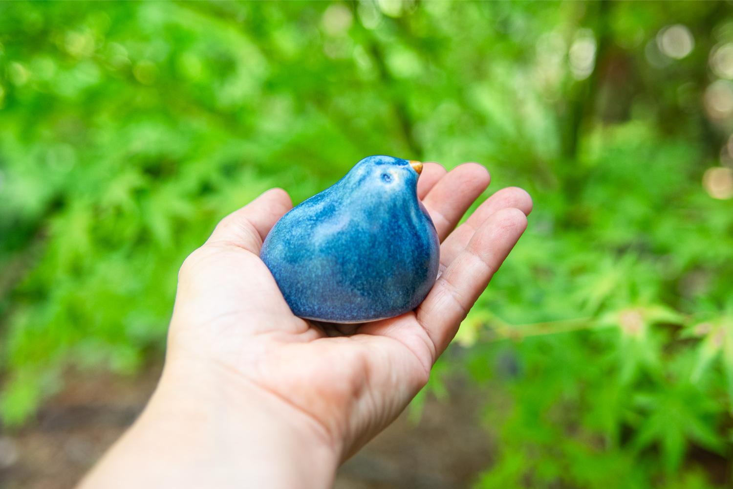 Glazed blue stoneware bird in a natural fiber nest - Image 2