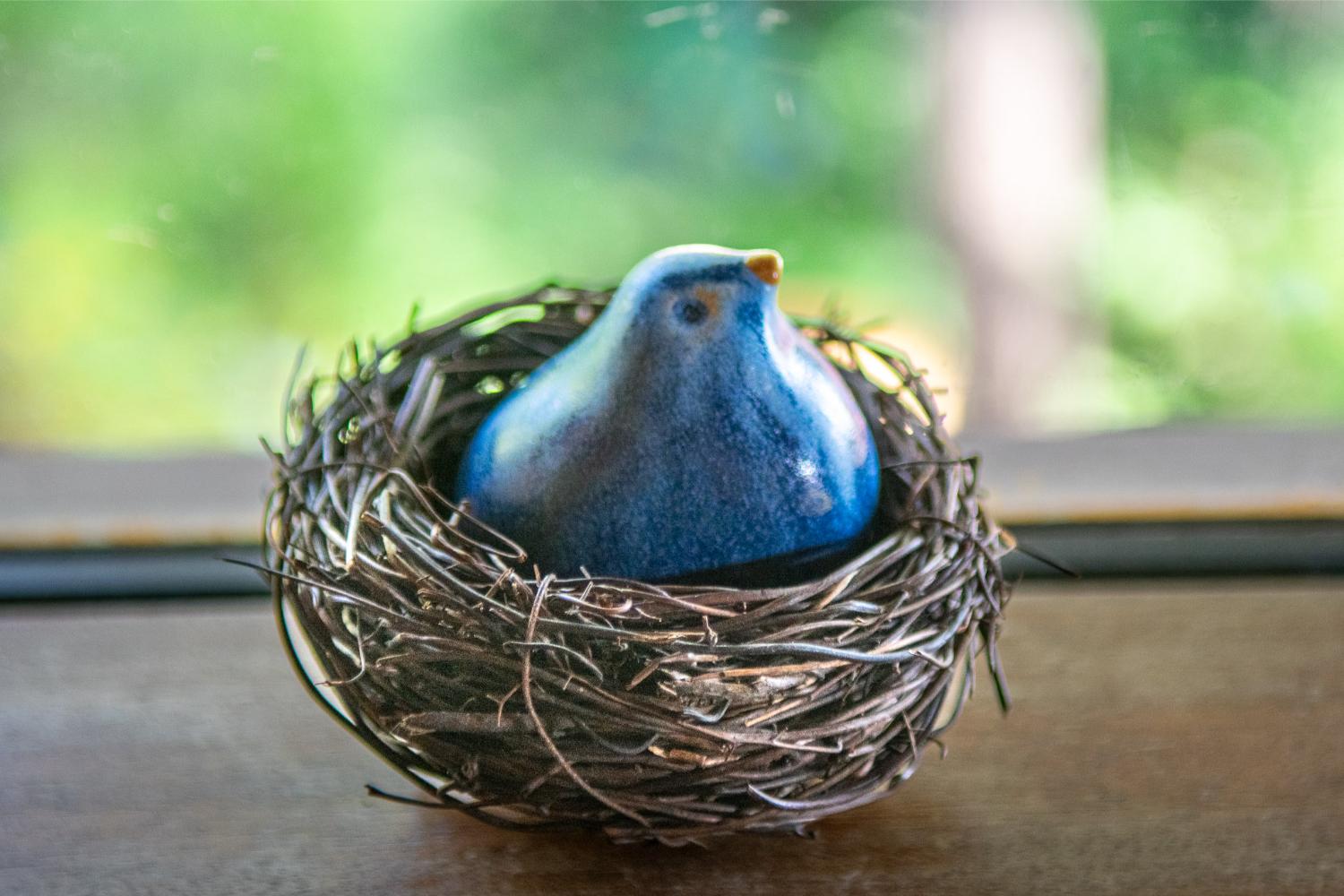 Glazed blue stoneware bird in a natural fiber nest - Image 3